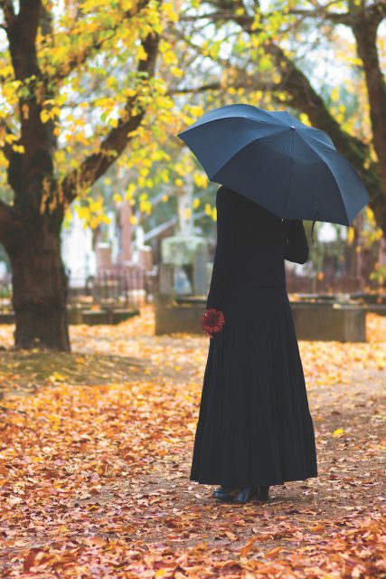 Woman in Mourning at Cemetery in Fall, with Black Umbrella