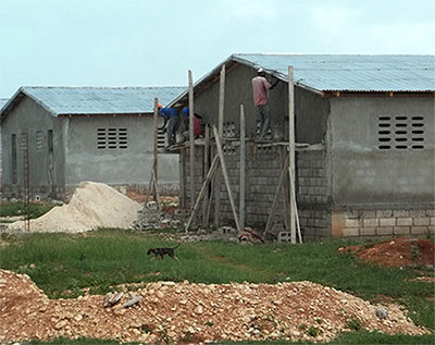MCC-supported construction of 100 homes (50 duplexes) in Cabaret, Haiti, is projected for completion by late February, allowing about 500 people currently living in tents to have permanent houses.  MCC Photo: Patrick Nelson