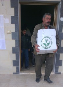 Ahmad Yousef is the father of 8 children, originally from a village called Koseir, near Homs, Syria. He was displaced and relocated to the village of Humaira, where he received this food package. Photo provided by Forum for Development, Culture and Dialogue.