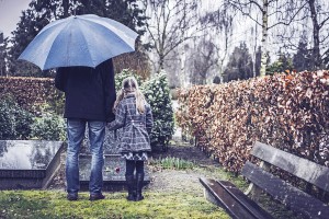 Father and daughter at graveyard
