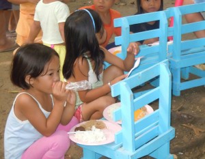 Children in the Philippines eat a meal provided by the Gleaners.