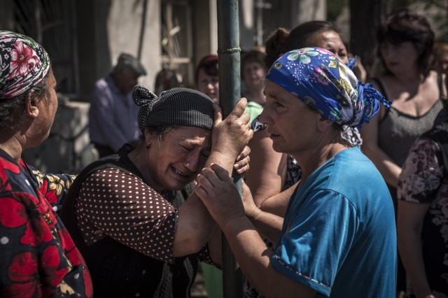 A woman bursts into tears during the morning meeting at the village which was shelled during an overnight artillery raid outside Slavyansk in eastern Ukraine. MCC Photo by Sergey Ponomarev.