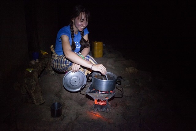 Rebecca Standen prepares her evening meal outside her house in the village of Capinga, near the city of Tete in Mozambique. Standen is an agricultural extensionist with MCC Mozambique. In 2014, she trained and supported community members where new sand dams are built. MCC, in partnership with Christian Council of Mozambique, has built 26 sand dams in the Tete region, between 2008 and 2014. MCC photo by Matthew Sawatzky
