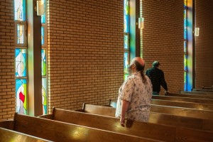 A congregation member contemplates the light. 