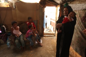 Caption for media: Syrian refugee Adra and her children received MCC-supported food vouchers and other humanitarian relief to supplement the occasional work her husband could find in Lebanon. (The family is not named for their protection.) (MCC Photo/Silas Crews)