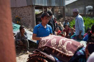  Jiwan Lama (volunteer) helps distribute winter supplies during a distribution done through MCC’s partner, Sansthagat Bikas Sanjal (Sanjal) in the village of Bhasbase, Nepal. The distribution provided materials to about 30 households in Dhading District, where homes were destroyed or heavily damaged by the April 25, 2015 earthquake. Sanjal operates through a network of local community based organizations. MCC has worked alongside Sanjal in the districts of Surkhet, Dhading, Okhaldunga and Banke districts on a variety of projects, such as HIV/AIDS prevention, food security, rural education, peacebuilding and disaster response. MCC photo by Matthew Sawatzky