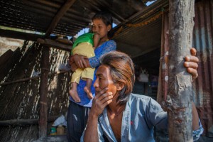  Sudarshan Chepang (22), Jamuna Chepang (18), baby boy Jibesh Chepang (16 months) in their temporary shelter in the village of Bhasebhase, in the Dhading District of Nepal. Their home was destroyed by an earthquake on April 25, 2015. MCC, through its partner, Sansthagat Bikas Sanjal (Sanjal), delivered winter supplies to Bhasbhase in December, 2015. Sanjal operates through a network of local community based organizations. MCC has worked alongside Sanjal in the districts of Surkhet, Dhading, Okhaldunga and Banke on a variety of projects, such as HIV/AIDS prevention, food security, rural education, peacebuilding and disaster response. MCC photo by Matthew Sawatzky